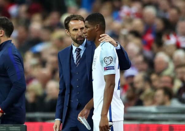 England's Marcus Rashford receives advice from caretaker manager Gareth Southgate. Picture: Nick Potts/PA