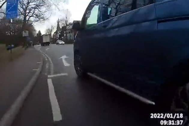 This is the moment a cyclist was knocked off his bike by a van that clipped him after changing lanes without looking while exiting a roundabout.
