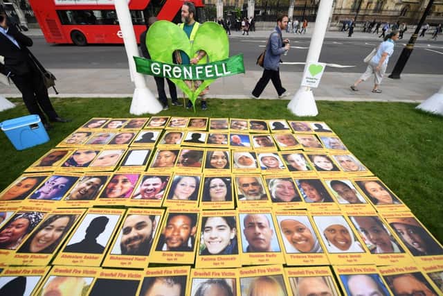 Photos of the victims of Grenfell Tower laid out. Credit: CHRIS J RATCLIFFE/AFP via Getty Images