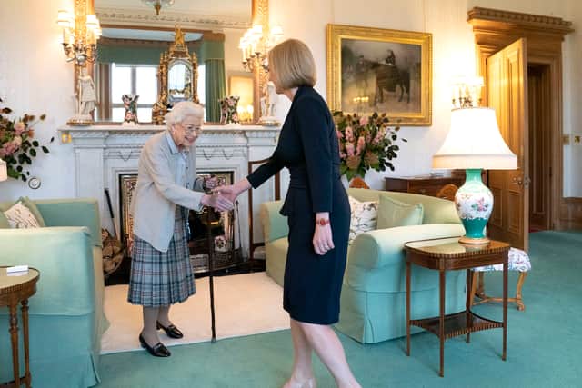 TOPSHOT - Britain’s Queen Elizabeth II and new Conservative Party leader and Britain’s Prime Minister-elect Liz Truss meet at Balmoral Castle in Ballater, Scotland, on September 6, 2022, where the Queen invited Truss to form a Government. - Truss will formally take office Tuesday, after her predecessor Boris Johnson tendered his resignation to Queen Elizabeth II. (Photo by Jane Barlow / POOL / AFP) (Photo by JANE BARLOW/POOL/AFP via Getty Images)