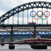 A London bus crosses the Tyne Bridge as the city of Newcastle prepares for the Olympic Torch Relay by displaying the Olympic rings on the landmark .