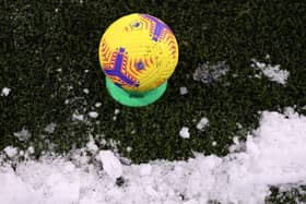 Football next to snow.  