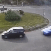 The moment a driver put their Need for Speed to the test as they drift around a busy roundabout.
