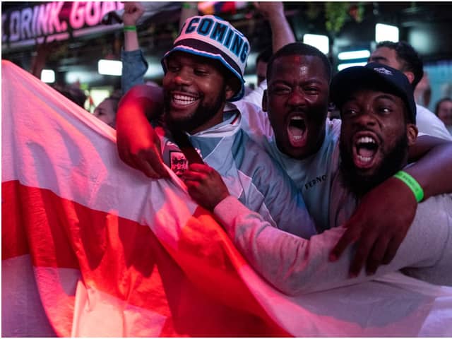 England fans cheer as they watch a live broadcast of the semi-final match between England and Denmark  (Getty Images)
