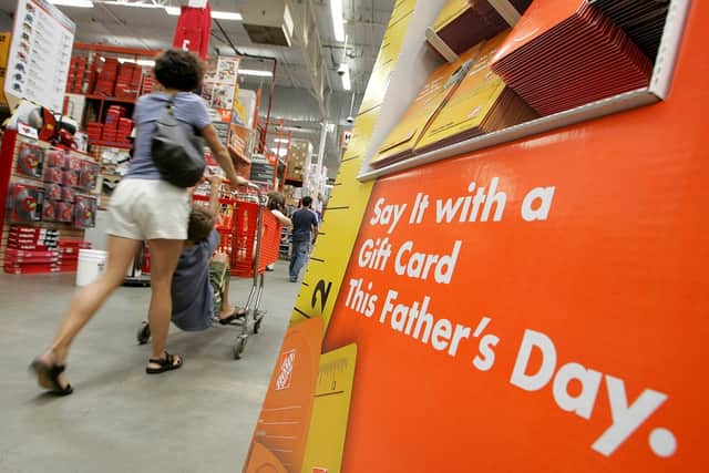 A Home Depot customer walks by a display of Father’s Day gift cards. (Pic credit: Justin Sullivan / Getty Images)