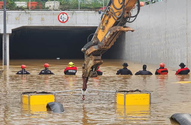 Rescue workers are searching for missing people after a tunnel flooded in South Korea