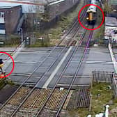 Man climbs train crossing barrier and strolls across tracks moments before a high speed train travels through at Station Road in Langley Green, Oldbury, West Midlands, on April 27, 2024.
