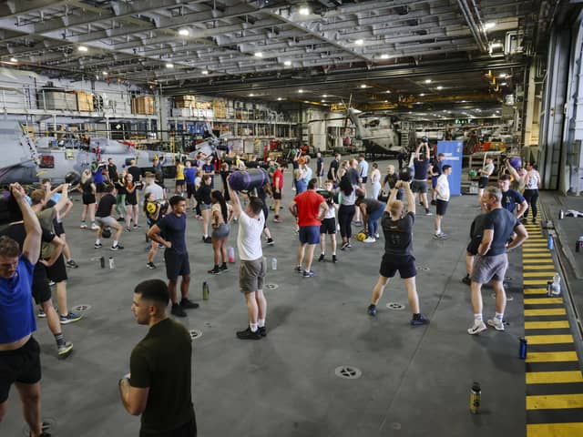 Here are all the details about the Royal Navy's Pre-Joining fitness test, and how you can beat it. Pictured are HMS Queen Elizabeth's ship's company take part in circuits in the hangar.
