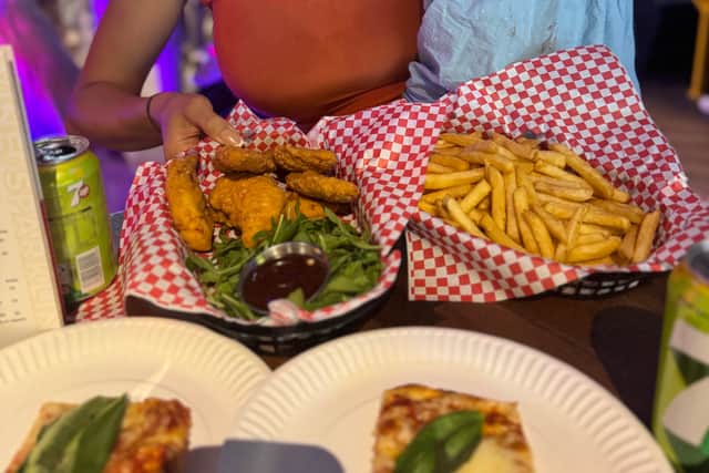 Pizza, chips and wings on offer. Sophie Mei Lan with daughter Athena Mei Lan Malin on opening night of King Pins.