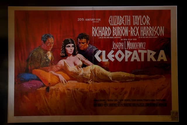 An original 1963 Cleopatra film poster celebrates the Egyptian queen’s enduring cultural legacy, here immortalised by Elizabeth Taylor — whose signed photograph also features in the exhibition.