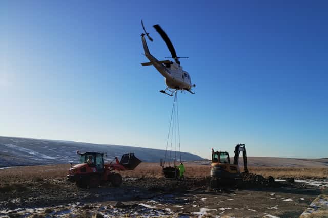 Bringing materials to the moorland hilltops by helicopter