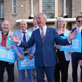 Reform UK leader Nigel Farage looking pleased with life during a visit to Havering Town Hall in Romford