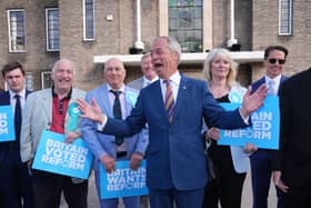 Reform UK leader Nigel Farage looking pleased with life during a visit to Havering Town Hall in Romford