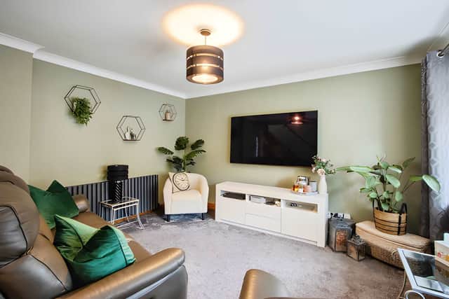 The welcoming lounge provides a comfortable main reception space with modern décor, carpeted flooring and stairs to the first floor