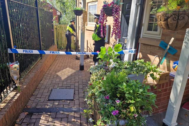 A bouquet of pink and white flowers have been left outside the property on Holywell Heights, Wincobank.