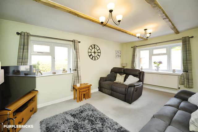 A comfortable living room features a log burner installed in 2024, creating a welcoming focal point