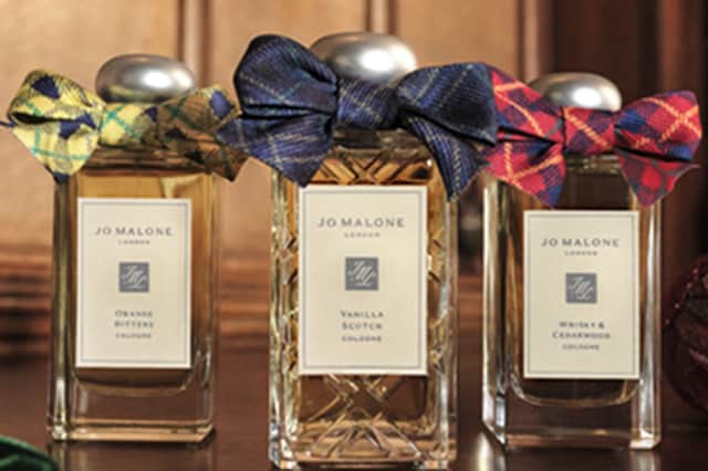 Jo Malone London's Christmas 2026 fragrance collection features Orange Bitters, the new Vanilla Scotch and Whisky & Cedarwood, each dressed in festive tartan bows.