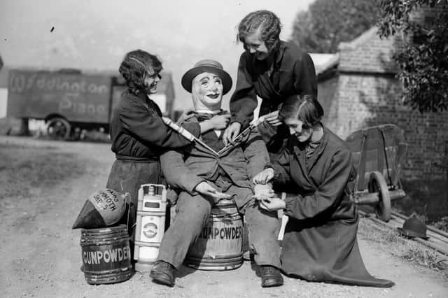 Three young women preparing a Guy Fawkes effigy in 1929.