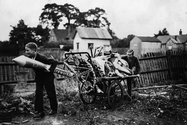 Two boys pulling a cartload of fireworks home in preparation for November 5th, Guy Fawkes night in October 1930.