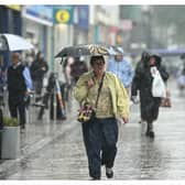 A woman carries an umbrella in the rain in Yorkshire.