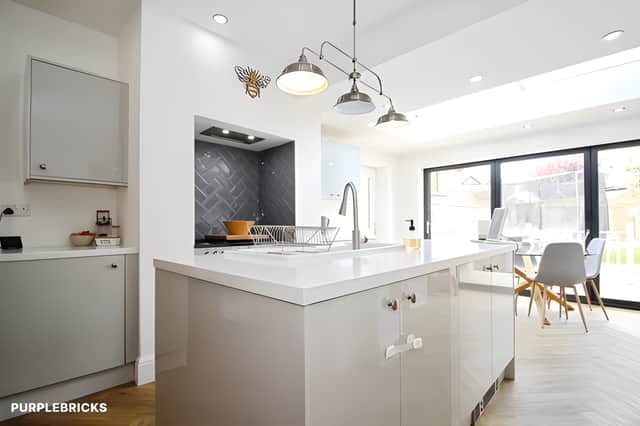 A central island, breakfast bar and walk-in pantry help make the extended kitchen diner a practical hub for cooking, family meals and entertaining