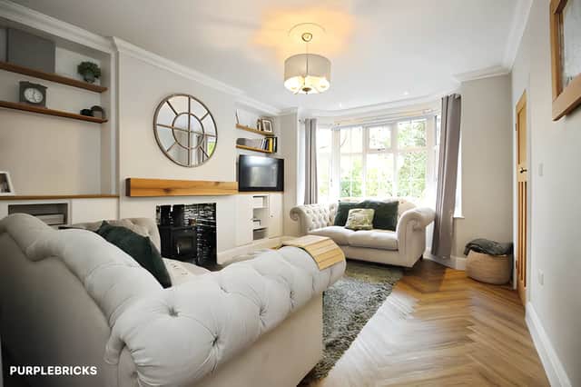 The lounge pairs neutral décor and bespoke storage with a log burner, creating a welcoming space that can be separated from the home's other reception rooms