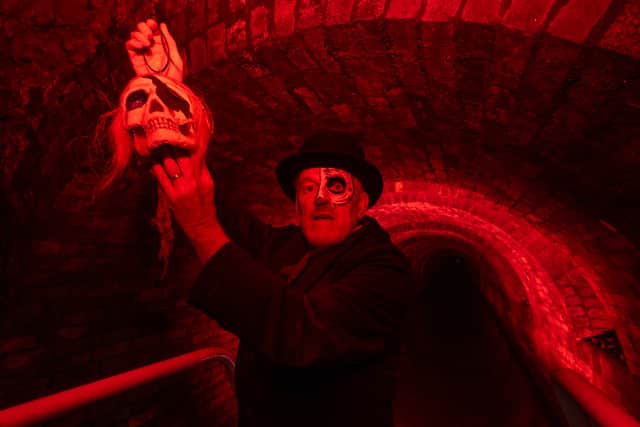 Canal & River Trust Trust volunteer, Clive Fearn poses for a photo on the canal trip boat as it passes through the Standedge Tunnel