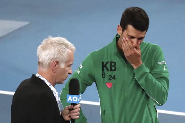 Novak Djokovic reacts as he is interviewed by John McEnroe about the death of friend Kobe Bryant following his quarter-final win over Canada's Milos Raonic at the Australian Open. Picture: AP/Dita Alangkara