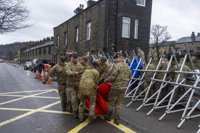 Soldiers from the Highlanders based at Catterick Garrison help build flood defences in Mytholmroyd inn the Calder Valley in preparation for Storm Dennis.