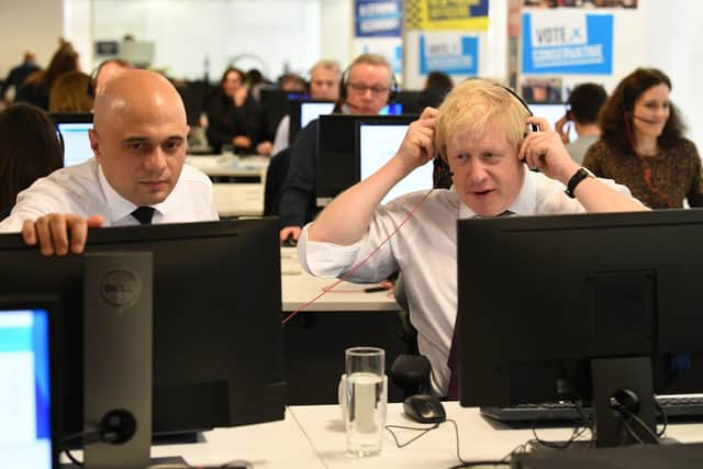 Prime Minister Boris Johnson (right) and Chancellor Sajid Javid with other members of the Cabinet at Conservative Campaign Headquarters Call Centre, London in December. Picture: Stefan Rousseau/PA Wire