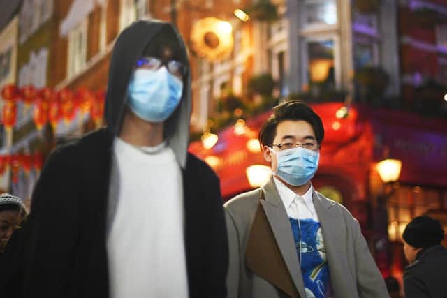 People wearing masks in China Town, London. Photo: Victoria Jones/PA Wire