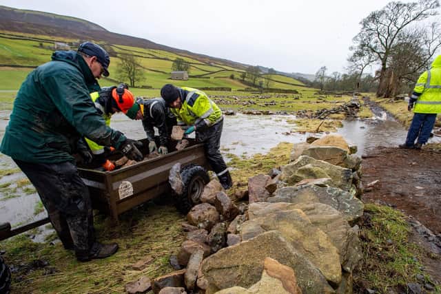 Volunteers helping the Yorkshire Dales National Park Authority repair flood damage in Swaledale where Storm Ciara and Dennis have washed away walls and footpaths along the River
