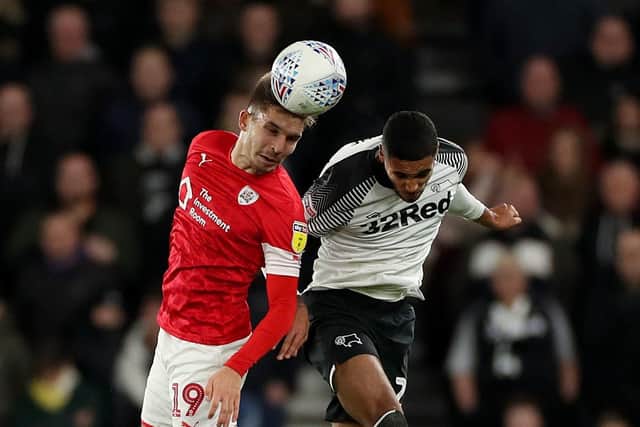 Barnsley's Patrick Schmidt (left) and Derby County's Max Lowe battle for the ball earlier this season. Picture: Bradley Collyer/PA