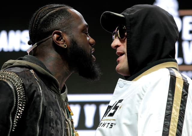 US boxer Deontay Wilder (L) and British boxer Tyson Fury get into an altercation during their press conference  (Picture: JOHN GURZINSKI/AFP via Getty Images)
