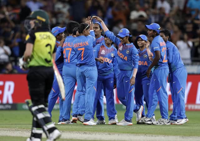 Victory: The Indian team celebrate their win over Australia in the first game of the Women's T20 World Cup in Sydney. Picture: AP Photo/Rick Rycroft