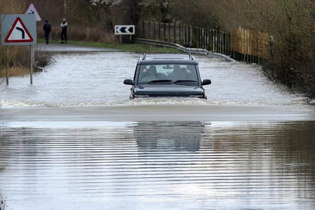 A car drives through flooding on a road near Fairburn Ings, Castleford.