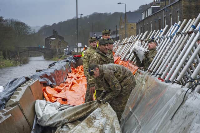 Soldiers from the Highlanders based at Catterick Garrison help build flood defences in Mytholmroyd inn the Calder Valley in preparation for Storm Dennis. Picture: Tony Johnson