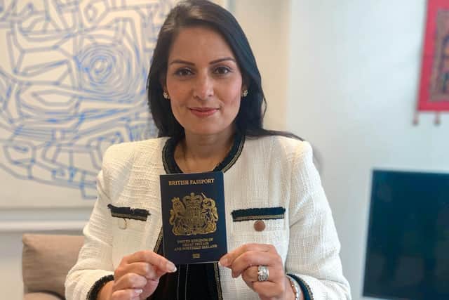 Home Secretary Priti Patel is pictured with one of the new blue post-Brexit passports.