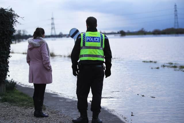 A police officer looks over flood water in the town of Snaith.