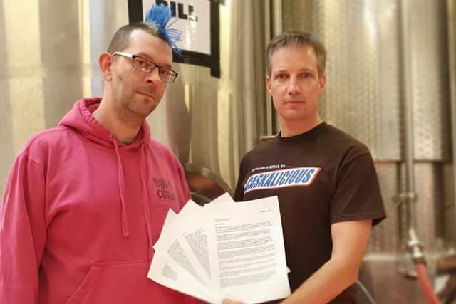 CAMRA members Kev Jones and Phil Saltonstall, both of Brass Castle
Brewery in Malton, with the open letter signed by 110 UK breweries