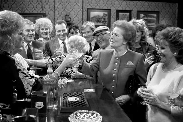 File photo from 1990 of former prime minister Margaret Thatcher toasting Julie Goodyear and the cast of Coronation Street when she visited the Rovers Return at Granada Television Studios in Manchester. Photo: PA/PA Wire
