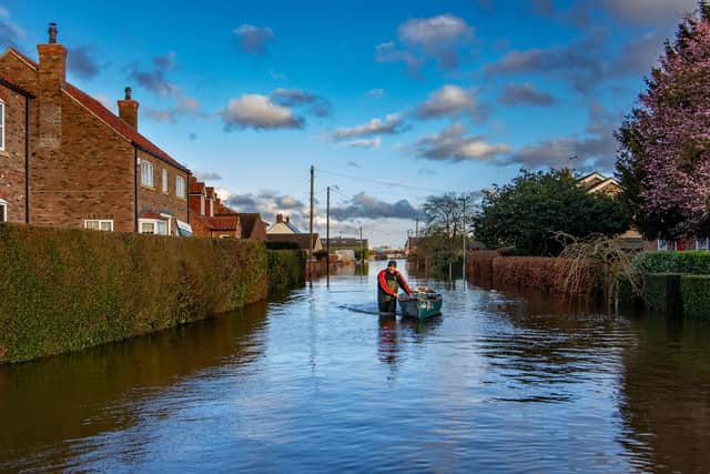 East Cowick resident David Goodwin keeps hold of his canoe whilst out on patrol along flooded Back Lane.
Picture; James Hardisty