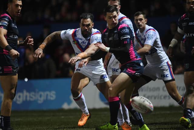 Wakefield Trinity's Ryan Atkins chips through in the way to his early try against Hull FC. (PIC:JONATHAN GAWTHORPE)