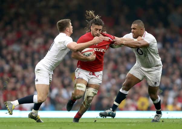 Wales' Josh Navidi (centre) is tackled by England's Owen Farrell (left) and Kyle Sinckler at the Principality Stadium last year. Picture: David Davies/PA
