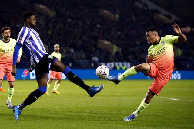 Sheffield Wednesday's Dominic Iorfa (left) and Manchester City's Gabriel Jesus battle for the ball.