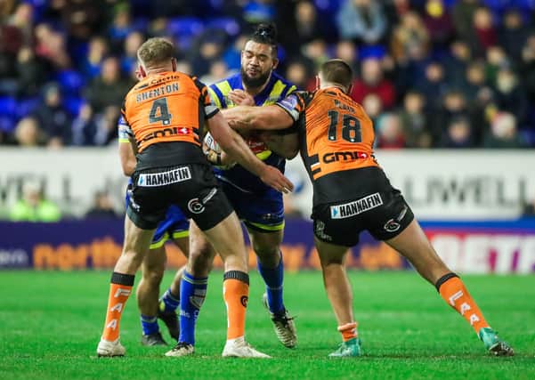 Warrington's Ben Murdoch-Masila is tackled by Castleford's Cheyse Blair and Michael Shenton.