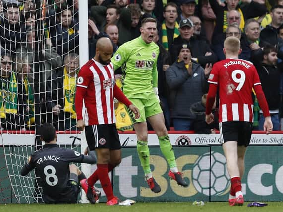 Dean Henderson celebrates his incredible double save against Norwich City