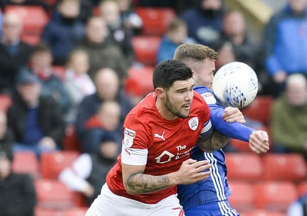Fighting for the cause: Barnsley's Alex Mowatt wins the ball in the air against Joe Ralls. Picture: Dean Atkins