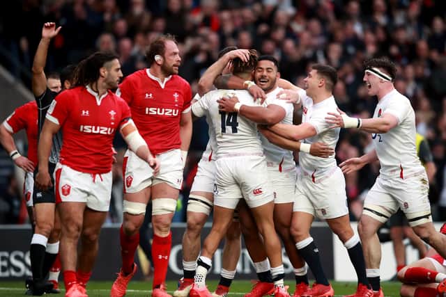 England's Anthony Watson (No.14) celebrates with his team-mates after scoring a try against Wales.