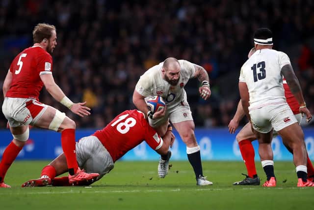 THERE MAY BE TOURBLE AHEAD: England's Joe Marler is tackled by Wales' Leon Brown at Twickenham. Picture: Adam Davy/PA